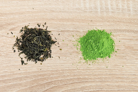 Green tea leaves on a table vs matcha powder