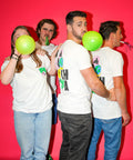 The PT team wearing colab t-shirts with baloons and party poppers.